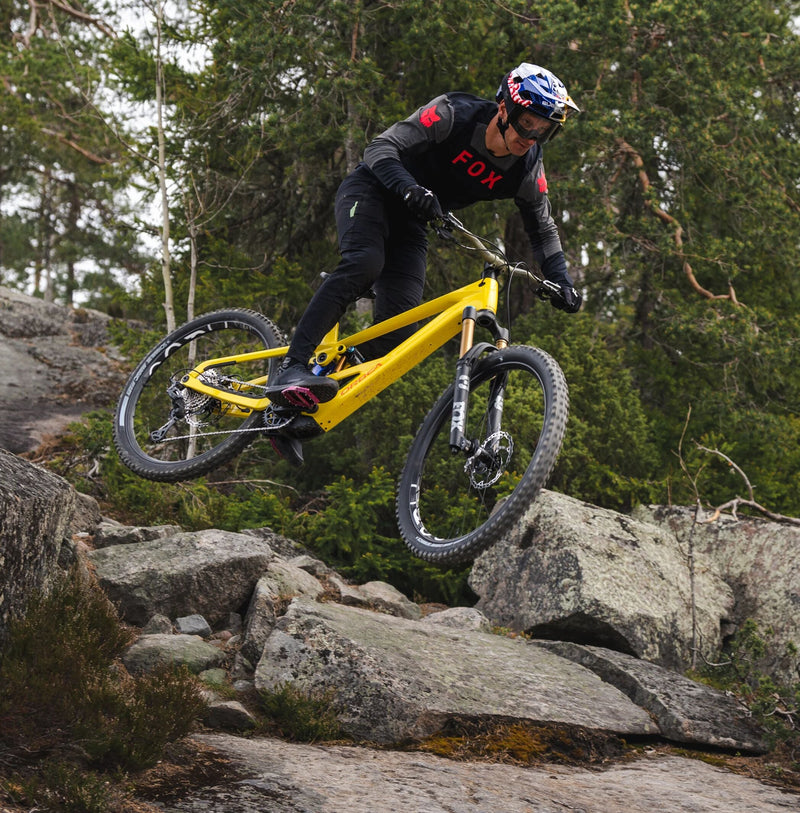 Red bull keppnishjólari brunar niður steinótta hlíð á nýju gulu Orbea Wild LT fulldempuðu rafmagnsfjallahjóli